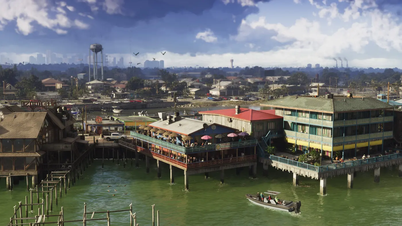 Quartier sur pilotis au bord de l'eau dans la région des Grassrivers de GTA VI, avec la skyline de Vice City visible au loin à l'horizon